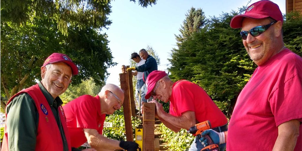 Members of Knights of Columbus Council 11780 build outdoor handrail for older parishioner couple